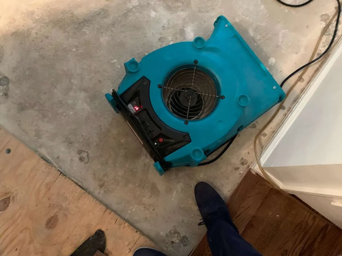 Air mover drying subfloor during Commercial Water Damage Restoration in Belpre